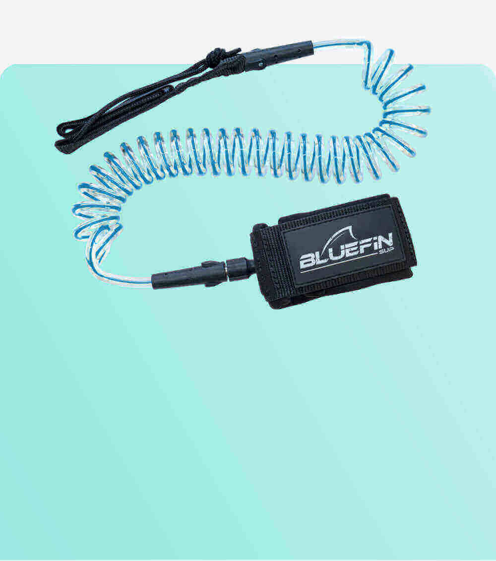 Coiled safety leash with black strap and blue cord, designed for paddleboarding use