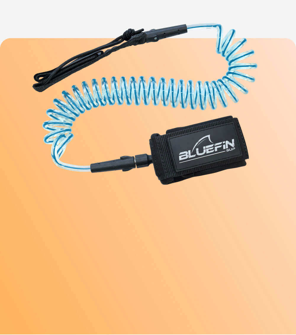 Coiled leash with black wrist strap and blue cord, featuring a BLACKFIN SUP logo on the strap.
