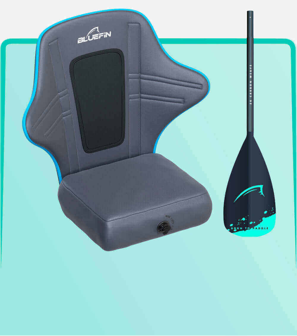 Gray inflatable seat with blue trim and back support next to a black paddle with teal accents