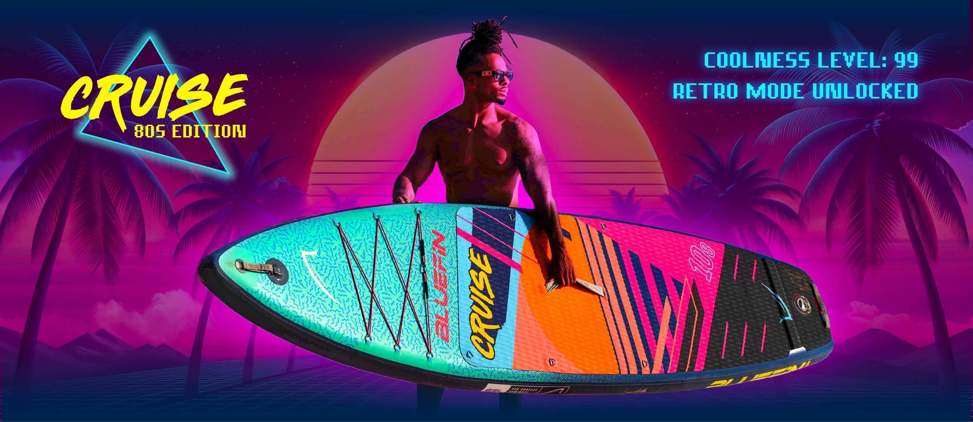 Inflatable paddleboard with colorful design, center fin, and textured deck pad, held by a person outdoors