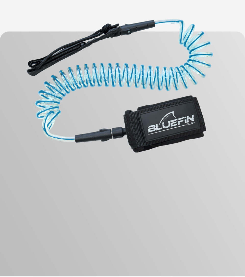 Coiled blue leash with a black strap labeled BLUEFIN SUP for paddleboarding safety.