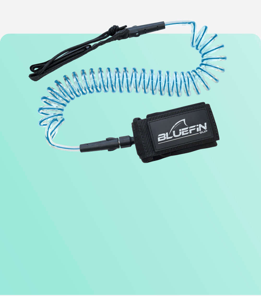 Coiled safety leash with black strap and blue cord, featuring a Bluefin SUP logo on the cuff