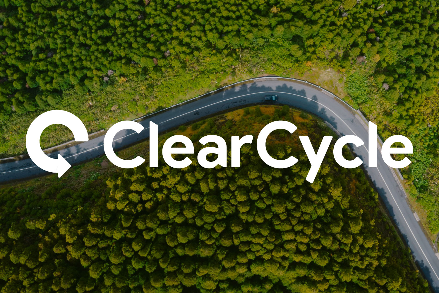 Aerial view of a winding road through dense green trees with ClearCycle logo overlay
