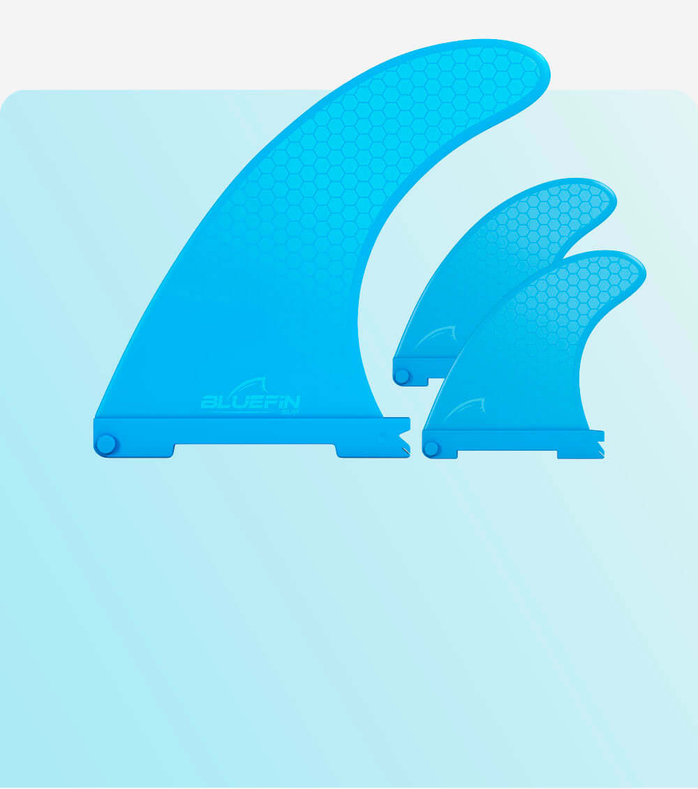 Three blue surfboard fins with a honeycomb pattern, varying in size, displayed on a light blue background.